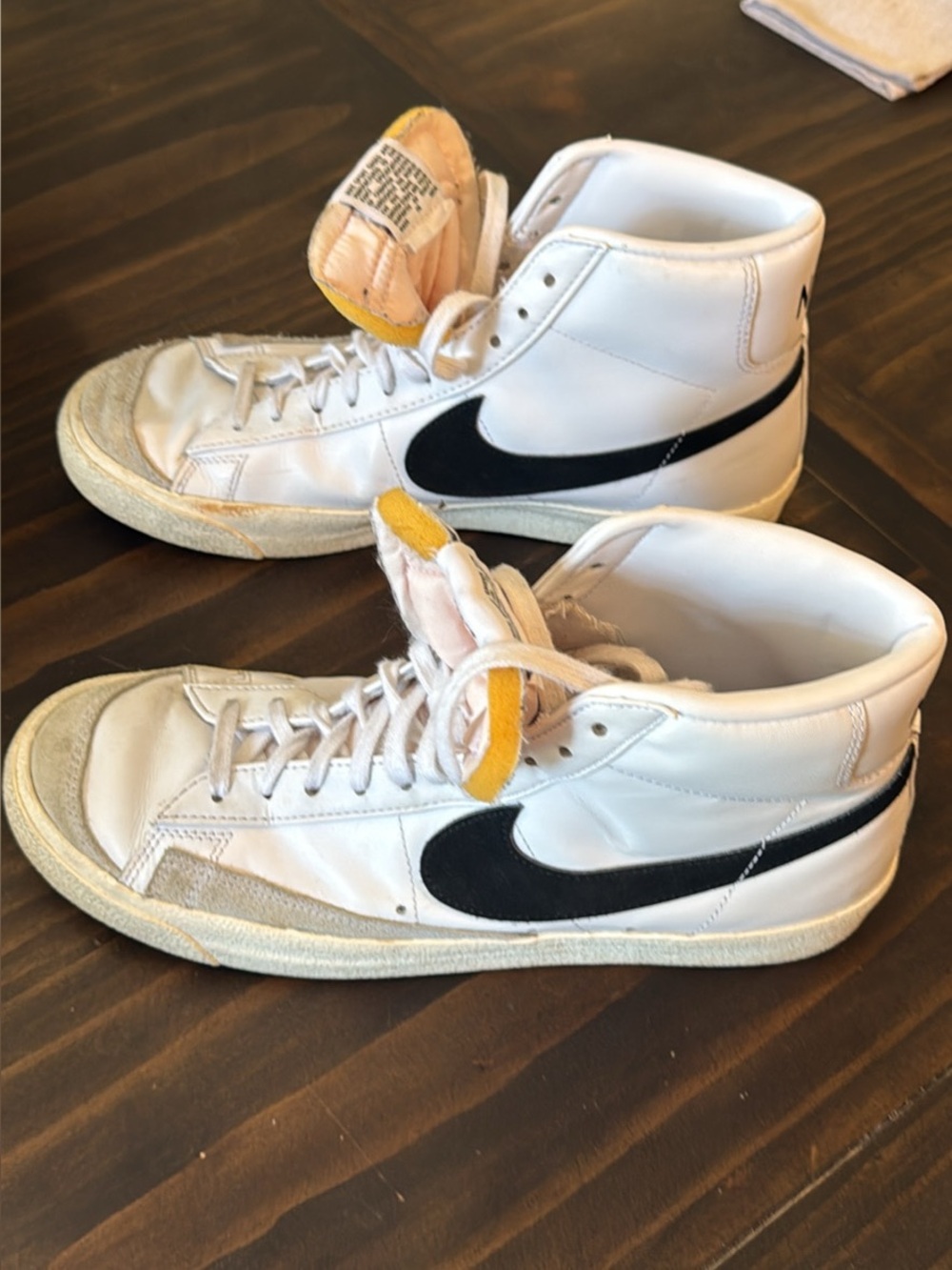 Nike White High-Top Sneakers with Black Swoosh